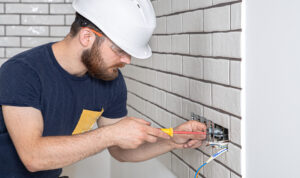 electrician builder at work installation of socket 7Z4Y2H9